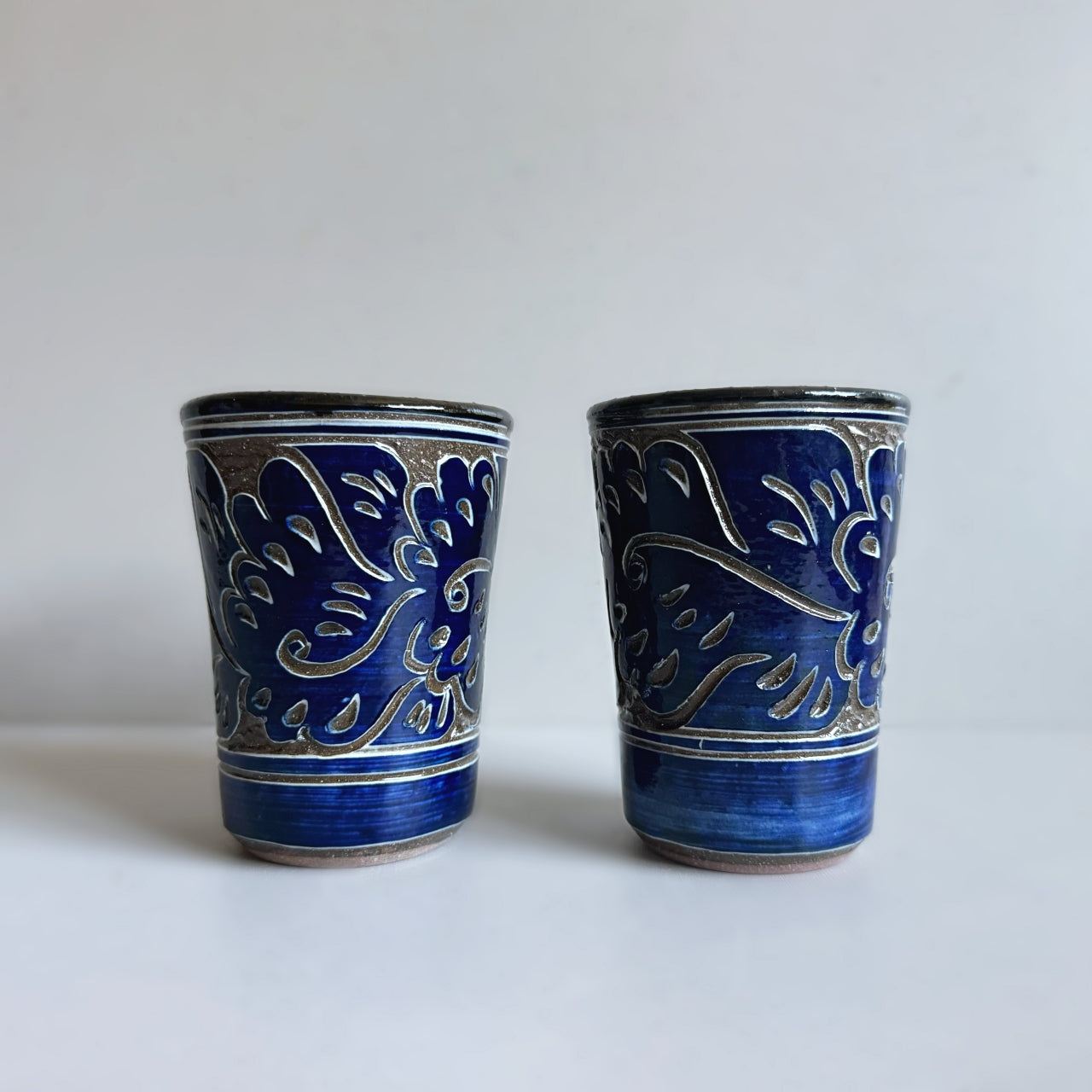 Japanese ceramic tumbler with carved Karakusa (Arabesque) pattern, handcrafted by Yachimun Yonamine in Japan. Available at Toka Ceramics.