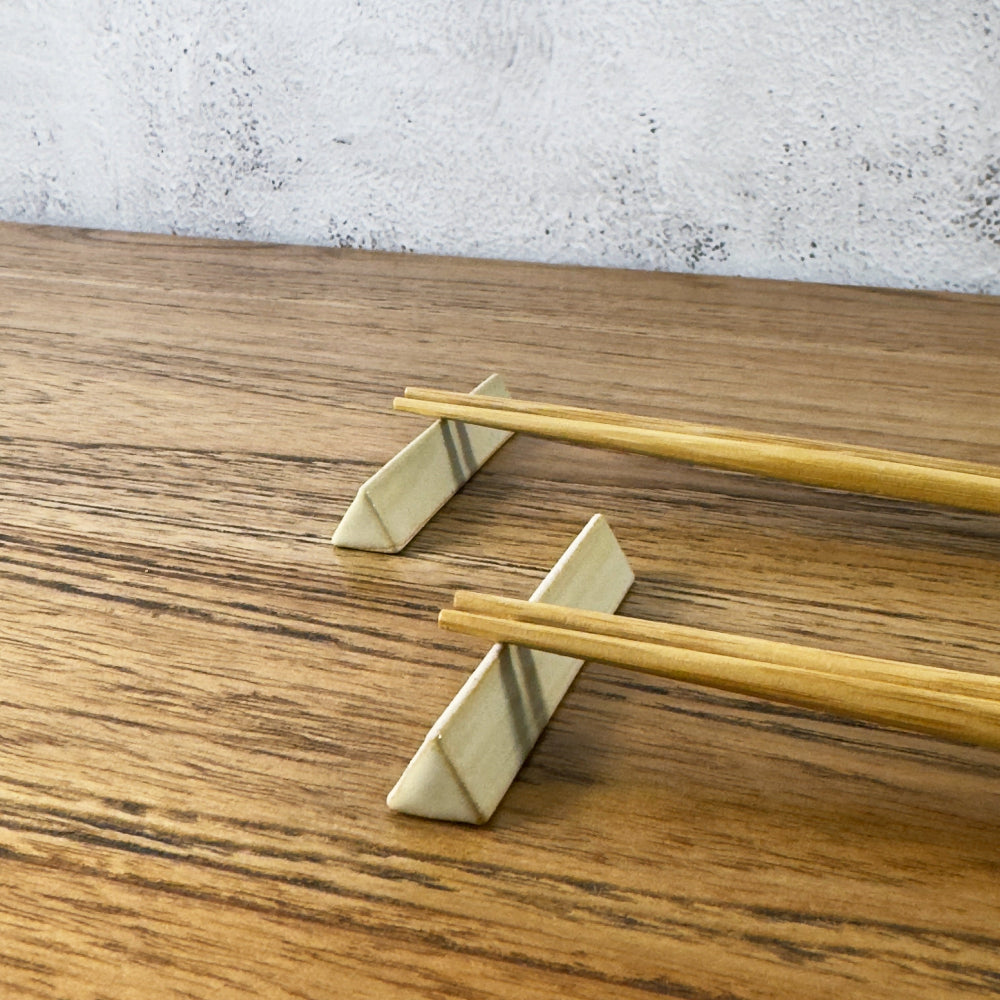 A triangular cutlery rest in cream colour, made in Japan. Available at Toka Ceramics.