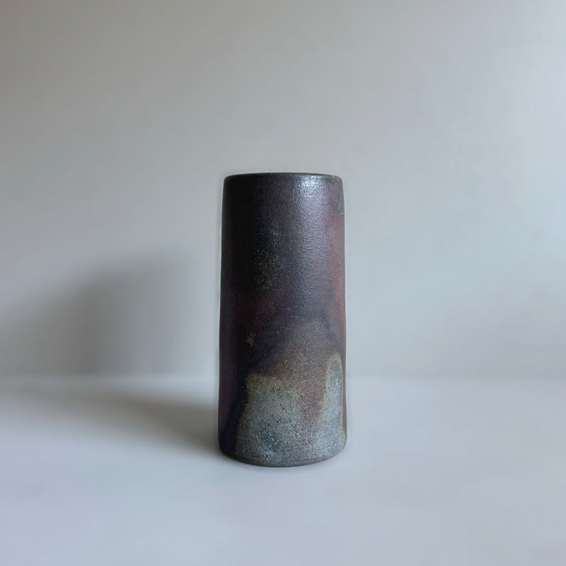 An earthy brown vase handcrafted by Tsugaru Kanayama Pottery in Japan. Large cylinder shape. Available at Toka Ceramics.