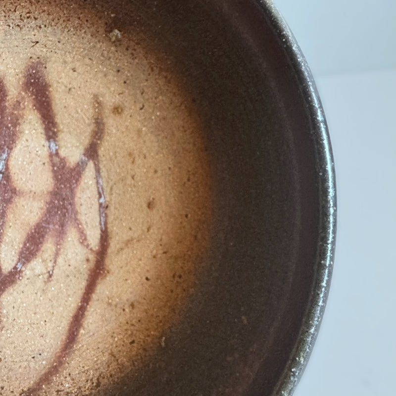 An earthy brown medium sized bowl without glaze. Handcrafted by Tsugaru Kanayama Pottery in Japan. Available at Toka Ceramics.