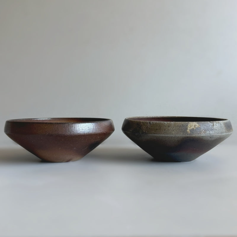 An earthy brown medium sized bowl without glaze. Handcrafted by Tsugaru Kanayama Pottery in Japan. Available at Toka Ceramics.